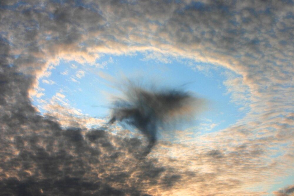 Rounded hole in a layer of clouds